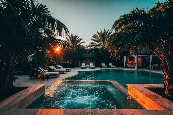 Resort-style pool and spa at sunset with cabana and palms, Central Florida